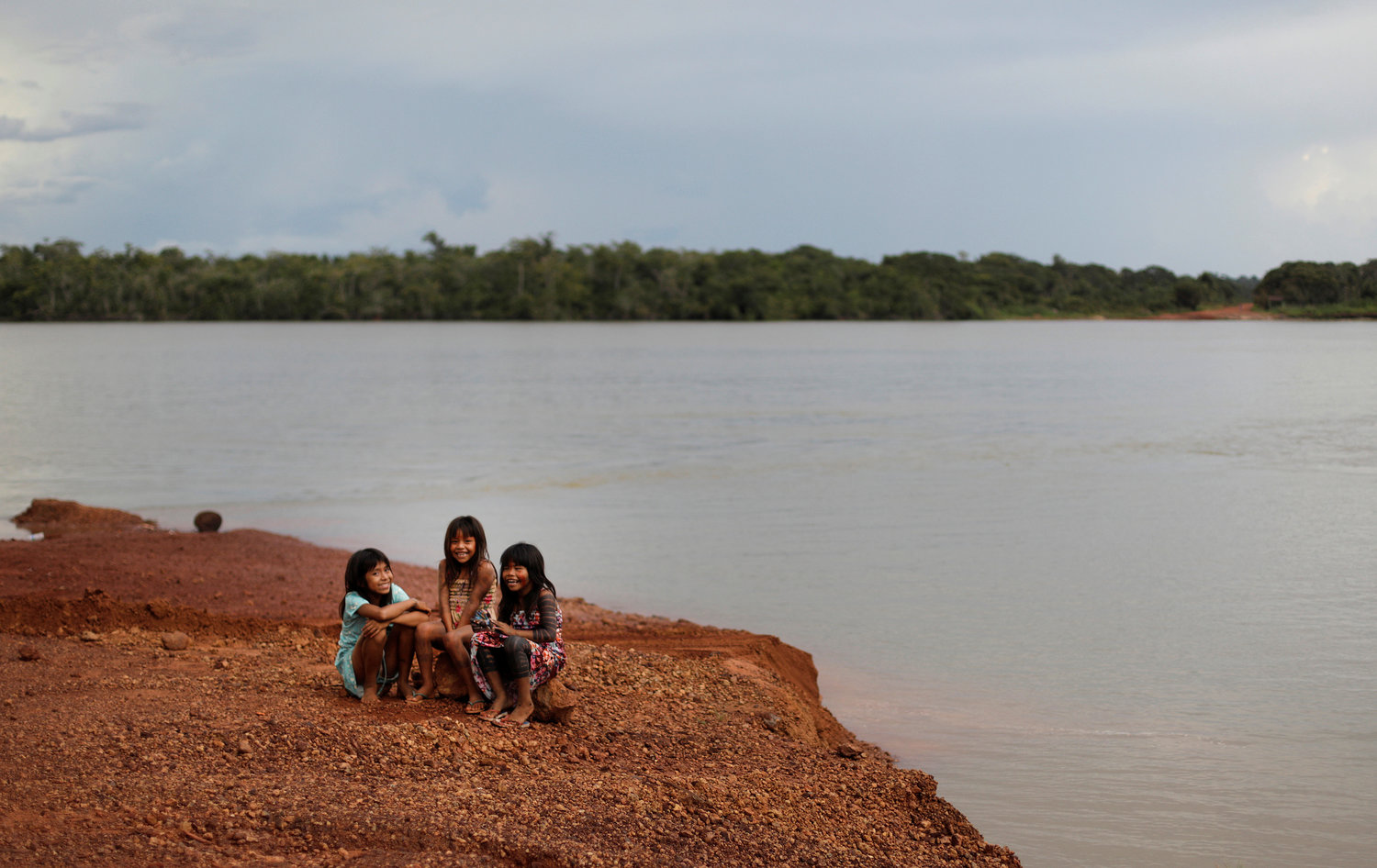 Indigenous children sit on the banks of the Xingu River in Brazil’s Xingu Indigenous Park Jan. 15, 2020.